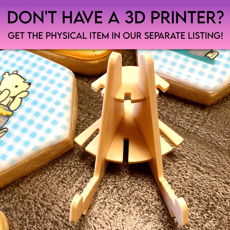 May include: A beige 3D printed stand for displaying cookies or other small items. The stand has a triangular base and two vertical supports that meet at the top. The stand is designed to hold items securely in place.