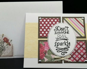 May include: A white card with a yellow background and four squares with different patterned paper. The squares are brown with a white border. The center square has a white circle with the text "Don't let anyone dull your sparkle".