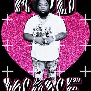 May include: A black and white zebra print graphic with the word "ROD" in pink letters. A man is standing in front of a pink glitter heart with the word "WAVE" in pink letters below the heart. The man is wearing a white t-shirt with the words "SAINT LAURENT" printed on it, blue jeans, and a gold chain necklace.
