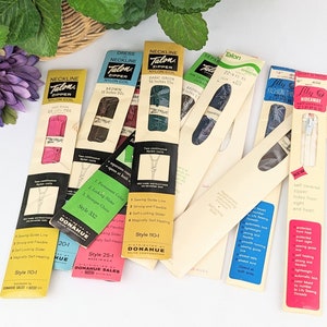 May include: Assortment of vintage Talon zippers in various colors and lengths, packaged in cardboard boxes with the brand name and style number printed on them. The boxes are labeled with descriptions like "Dress Neckline Zipper", "Neckline Zipper", and "Fashionway Zipper".