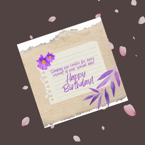 Może przedstawiać: Kartka urodzinowa z ręcznie napisanym przesłaniem na kawałku papieru z fioletowym wzorem kwiatowym. Wiadomość brzmi "Sending you smiles for every moment of your special day! Happy Birthday!"