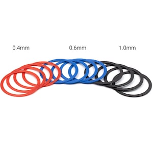 May include: A set of three sizes of rubber rings, red, blue, and black, labeled 0.4mm, 0.6mm, and 1.0mm.
