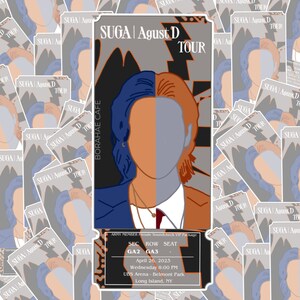 May include: A ticket-style design featuring the text "SUGA | Agust D TOUR" with a split-face illustration in blue and orange. The ticket includes event details: April 26, 2023, UBS Arena, Long Island, NY.