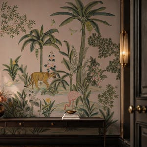 May include: A wall mural featuring a jungle scene with palm trees, a tiger, a flamingo, and a monkey in a tree. A dark brown console table sits in front of the mural, holding a metallic vase with peach flowers and a stack of books.