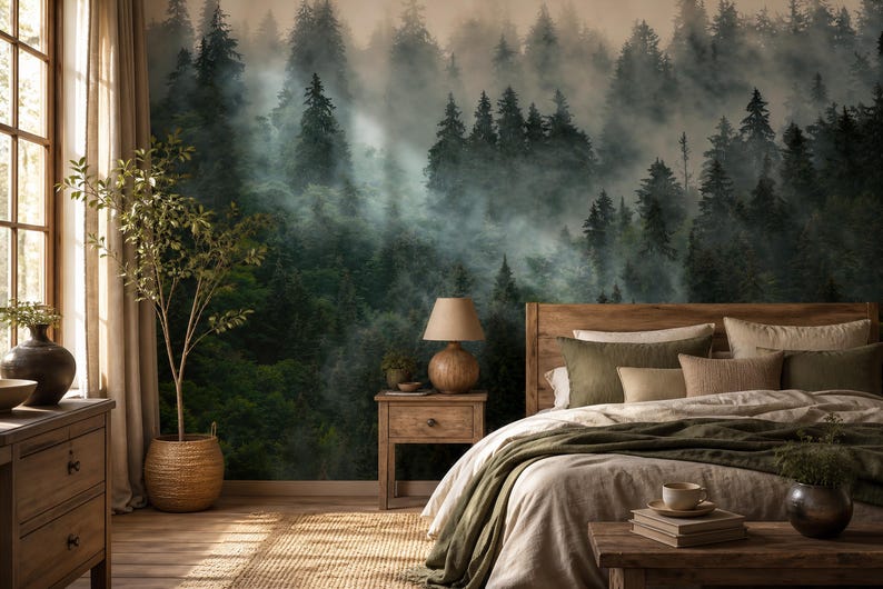 May include: A bedroom with a forest mural, a wooden bed frame, and a nightstand with a lamp. The bed has green and beige bedding. A large window with curtains and a potted plant are on the left.