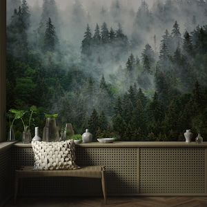 May include: A serene interior scene featuring a forest mural as a backdrop. A woven bench holds a textured pillow. Decorative vases and a bowl sit on a wooden ledge. The room has a natural, calming aesthetic.