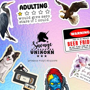 May include: A set of 10 vinyl stickers featuring various designs, including a heron, an eagle, a unicorn, a zombie, a floral design, and a VHS tape. The stickers have humorous text, such as "Adulting would give zero stars if I could" and "Warning: This is my private beer fridge".