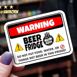 May include: White warning sign with black and red text that reads "WARNING BEER FRIDGE DO NOT PUT FOOD, WATER, OR THINGS NOT BEER IN THIS FRIDGE!" The sign has a yellow exclamation point, a black and white circle with the text "STRICTLY THE BEER" and a black and white beer bottle graphic, a yellow triangle with a black exclamation point, and a black and white circle with a slash through a beer bottle graphic.