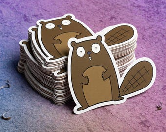 May include: A stack of die-cut stickers featuring a cartoon beaver with wide, surprised eyes, a brown body, a lighter tan belly, and a dark brown tail with a cross-hatched pattern. The beaver has two small white teeth visible in its mouth.