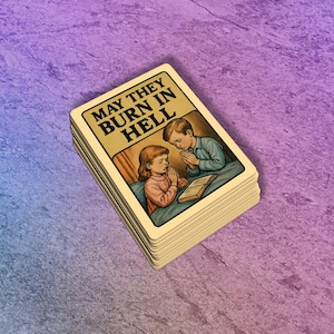May include: A stack of playing cards with the text "MAY THEY BURN IN HELL" at the top. The card illustration depicts two children praying over an open book. The background is a gradient of purple and blue.