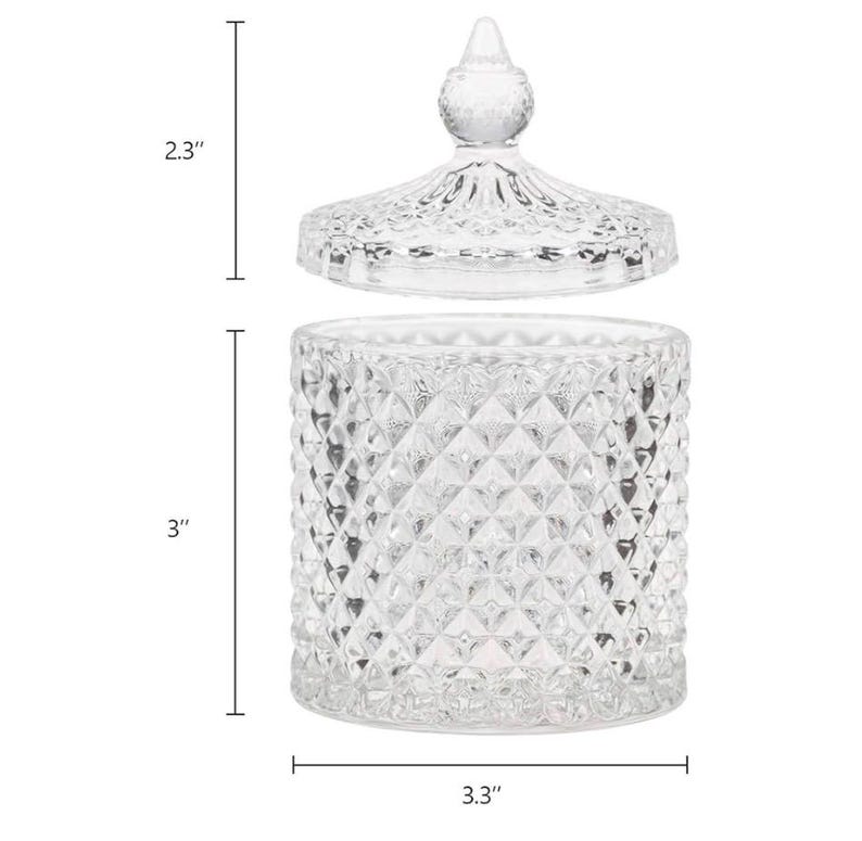 May include: A clear glass jar with a lid, featuring a diamond pattern. The jar is 3 inches tall and 3.3 inches wide. The lid is 2.3 inches tall. The jar is designed to hold small items and has a decorative appearance.