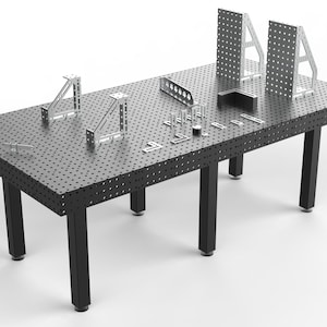May include: A black welding table with a perforated surface and black legs. Various metal welding accessories are arranged on the table, including angle brackets, squares, and plates. The table is designed for metalworking and fabrication.