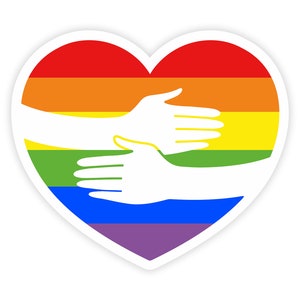 Könnte beinhalten: Ein Regenbogenherz mit zwei Händen, die sich in einem Zeichen von Einheit und Akzeptanz entgegenstrecken.