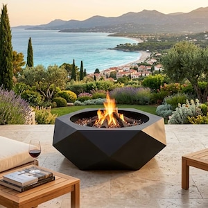 Pode incluir: Uma lareira geométrica preta com fogo ardente, num pátio com vista panorâmica do oceano. Um copo de vinho tinto e livros numa mesa de madeira. A lareira é rodeada por um jardim exuberante.