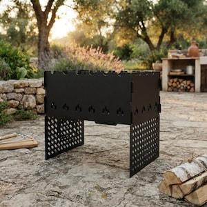 May include: A black metal portable grill with a rectangular firebox featuring laser-cut flame motifs along the sides and a diamond-patterned lattice design on the support legs. The grill has notched edges along the top rim for skewers.