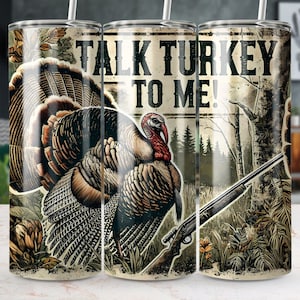 May include: A set of three stainless steel tumblers with a hunting theme. The tumblers feature a brown and white turkey with a camouflage background and the text "Talk Turkey To Me!"