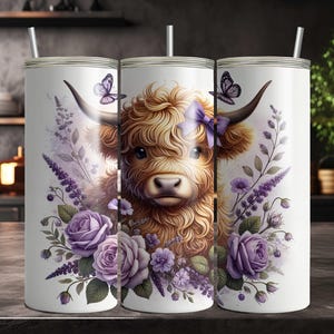 May include: A white stainless steel tumbler with a design of a Highland cow with purple flowers and butterflies. The cow has a purple bow on its head.