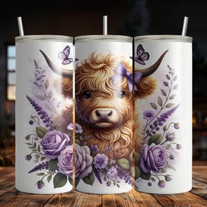 May include: A white stainless steel tumbler with a purple floral design and a Highland cow with a purple bow. The cow is brown and white with a fluffy mane.