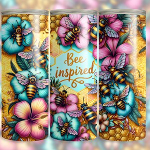 May include: A tumbler with a floral and bee design. The tumbler features turquoise and pink flowers, with bees and the words "Bee inspired" in a gold script. The background has a honeycomb pattern.