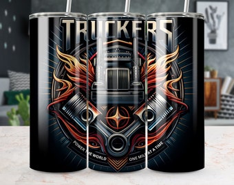 May include: A black and silver tumbler with a graphic of a semi-truck with flames and pistons. The text "Truckers" is at the top of the design. The text "Power the World" is on the left side of the design and "One Mile at a Time" is on the right side of the design.