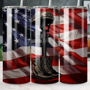 May include: A stainless steel tumbler with a design featuring an American flag, a military helmet, a rifle, and a pair of combat boots. The design is a tribute to fallen soldiers.
