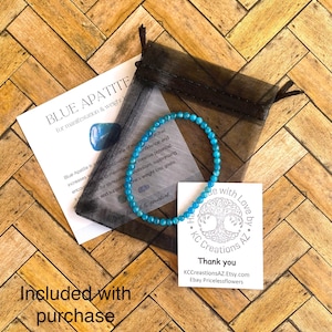 May include: Blue apatite bracelet with a tree charm and the text "Handmade with Love by KC Creations AZ". The bracelet is in a small black mesh bag. The text "Thank you" is on a white card with the text "KCCreationsAZ.Etsy.com Ebay Pricelessflowers".