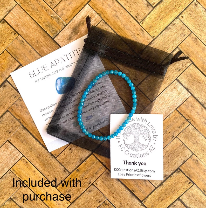 May include: Blue apatite bracelet with a tree charm and the text "Handmade with Love by KC Creations AZ". The bracelet is in a small black mesh bag. The text "Thank you" is on a white card with the text "KCCreationsAZ.Etsy.com Ebay Pricelessflowers".
