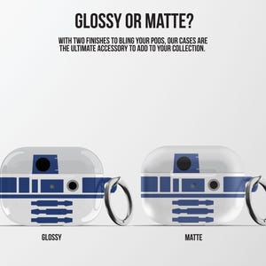 May include: Two white and blue R2-D2-themed AirPods cases, one glossy and one matte, with silver key rings. The text "GLOSSY OR MATTE?" and "WITH TWO FINISHES TO BLING YOUR PODS, OUR CASES ARE THE ULTIMATE ACCESSORY TO ADD TO YOUR COLLECTION." are at the top.