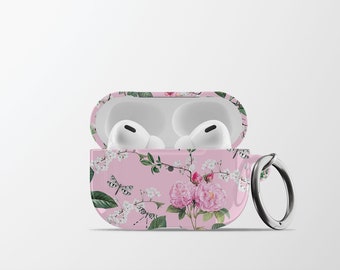 May include: A pink floral patterned case for wireless earbuds with a silver ring attached. The case is open and the earbuds are visible inside.