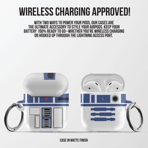 May include: White and blue AirPod cases with a design. One case is closed, and the other is open, revealing white earbuds. The cases have a silver keyring and the text "WIRELESS CHARGING APPROVED!" is at the top.