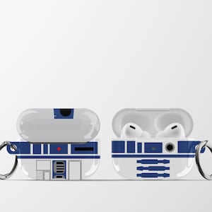 May include: White and blue protective case for wireless earbuds, featuring a design inspired by a droid. The case is shown open and closed, with a silver carabiner clip attached. The design includes rectangular and circular details.