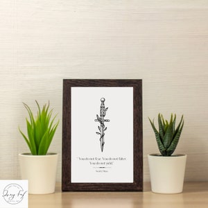 May include: A black and white illustration of a sword with vines growing around it. The quote "You do not fear. You do not falter. You do not yield." by Sarah J. Maas is printed below the image.