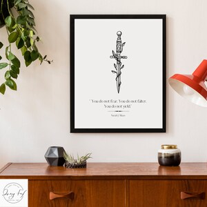 May include: Black and white printable art print featuring a stylised dagger with vines wrapped around it. The print includes the quote "You do not fear. You do not falter. You do not yield." by Sarah J. Maas.