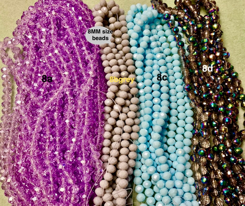 May include: Four strands of 8mm faceted glass beads. The strands are purple, light grey, light blue, and iridescent brown. The text "8MM size beads" is visible in the image.