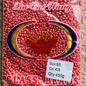 May include: A bag of pink glass beads, labelled "Xin Cai Wang" and "CLASS BEADS". The label also includes the size, colour, and quantity: "Size: 6/0, Col: 405, Qty: 450g".