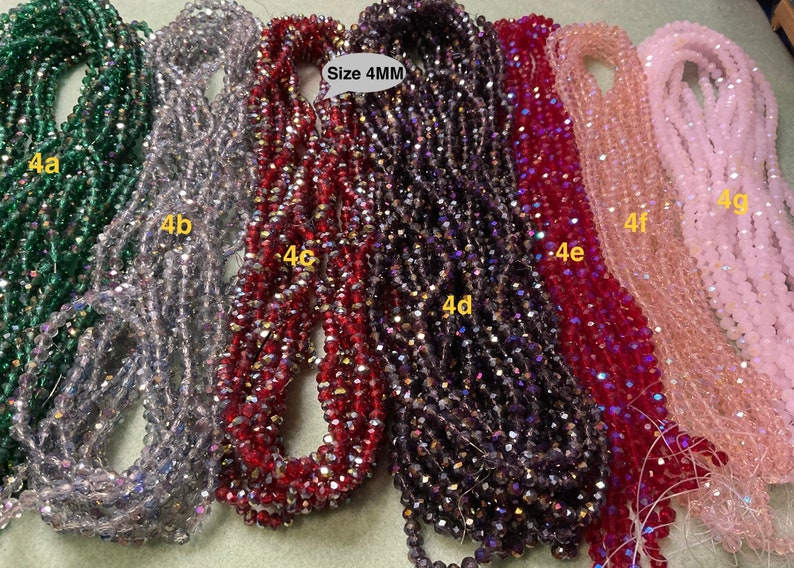 May include: Assortment of 4mm crystal beads in various colours, including green, silver, red, purple, pink, and light pink. The beads are arranged in rows and labelled with letters and numbers, such as 4a, 4b, 4c, 4d, 4e, 4f, and 4g. The text "Size 4MM" is also visible in the image.