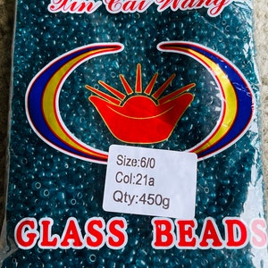 May include: A bag of teal blue glass beads, labelled "Xin Cai Wang Glass Beads" with the details "Size: 6/0 Col: 21a Qty: 450g".