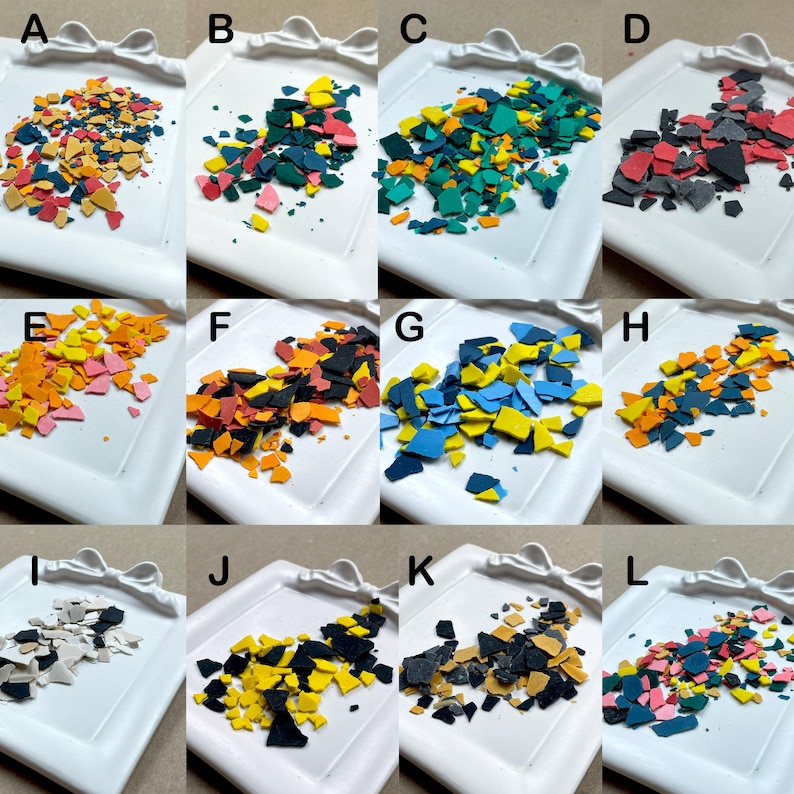 May include: A collection of colorful, irregularly shaped pieces arranged on a white, decorative tray. The pieces vary in color, including shades of orange, yellow, blue, green, and pink. The tray has a bow-shaped design on the edge.
