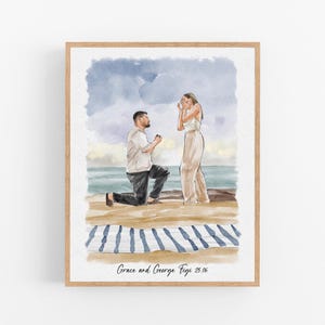 May include: A watercolor print in a wooden frame depicting a proposal on a beach. One figure kneels on the sand while the other stands with hands to their face. A blue and white striped blanket lies on the sand. Text reads Grace and George Figi 25.06.