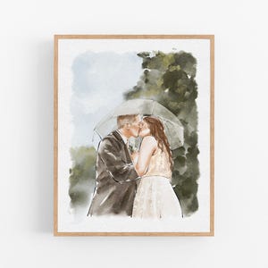 May include: A watercolor painting in a light wood frame depicting two people kissing under a clear umbrella. The person on the left wears a dark suit, and the person on the right wears a light-colored dress. The background features soft green foliage.