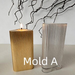 May include: A lit gold candle and a clear, ribbed, rectangular mold. The candle is burning with a bright flame. The mold is next to the candle. The text "Mold A" is in white letters.