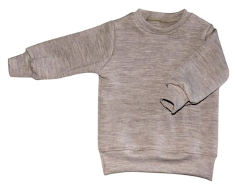 Jersey infantil de lana merino. Color beige liso, tallas 74-170.