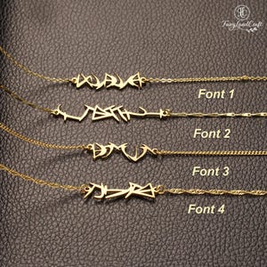May include: Four gold-colored necklaces featuring custom name pendants in distinct graffiti-style fonts. Each necklace is labeled with text indicating Font 1, Font 2, Font 3, and Font 4, showcasing different angular and stylized lettering designs.