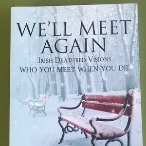 May include: Book cover with a snowy forest scene and a red bench. The title is "We'll Meet Again" and the subtitle is "Irish Deathbed Visions: Who You Meet When You Die". The author is Colm Keane, author of the No. 1 bestseller "Going Home."