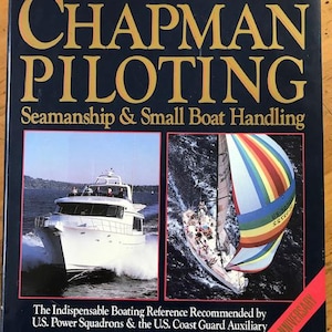 May include: The cover of the 60th edition of Chapman Piloting, a book about seamanship and small boat handling. The cover features a photo of a white motorboat and a sailboat with a rainbow-coloured sail. The book is recommended by the U.S. Power Squadrons and the U.S. Coast Guard Auxiliary. The author is Elbert S. Maloney.