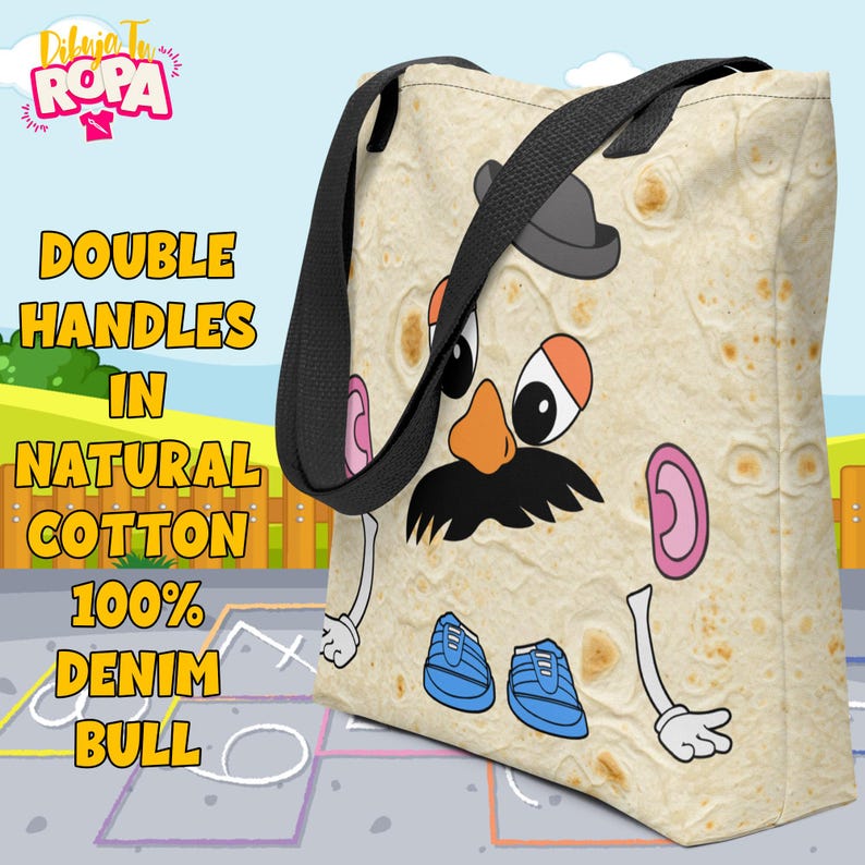 May include: A beige tote bag with a cartoon Mr. Potato Head design. The bag has black double handles and the text "DOUBLE HANDLES IN NATURAL COTTON 100% DENIM BULL" in yellow. The bag is made of natural cotton.