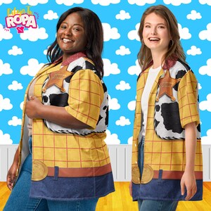 May include: Yellow and red plaid button-up shirt with a cow print accent and a sheriff badge. The shirt has a brown belt and blue denim-like bottom. The shirt is inspired by a popular animated movie character.