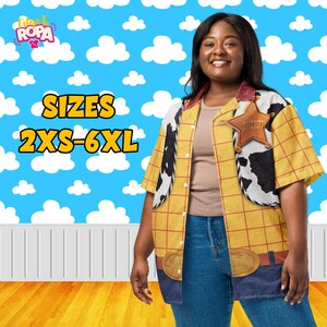 May include: A yellow button-down shirt with a red plaid pattern, black and white cow print accents, and a Sheriff badge. The shirt has a brown belt design at the bottom and is available in sizes 2XS-6XL. The background is a blue sky with white clouds.