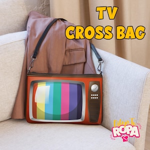 May include: A novelty crossbody bag shaped like a vintage television set. The bag is orange with a colorful striped screen and a black strap. The text "TV CROSS BAG" is displayed in yellow.