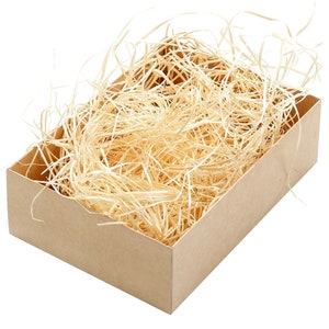 May include: A brown cardboard box filled with light brown wood wool packing material.